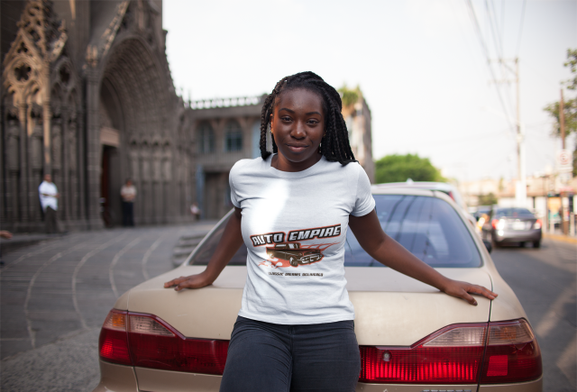 girl-with-dreadlocks-wearing-a-round-neck-tee-mockup-while-lying-against-an-old-car-a15951